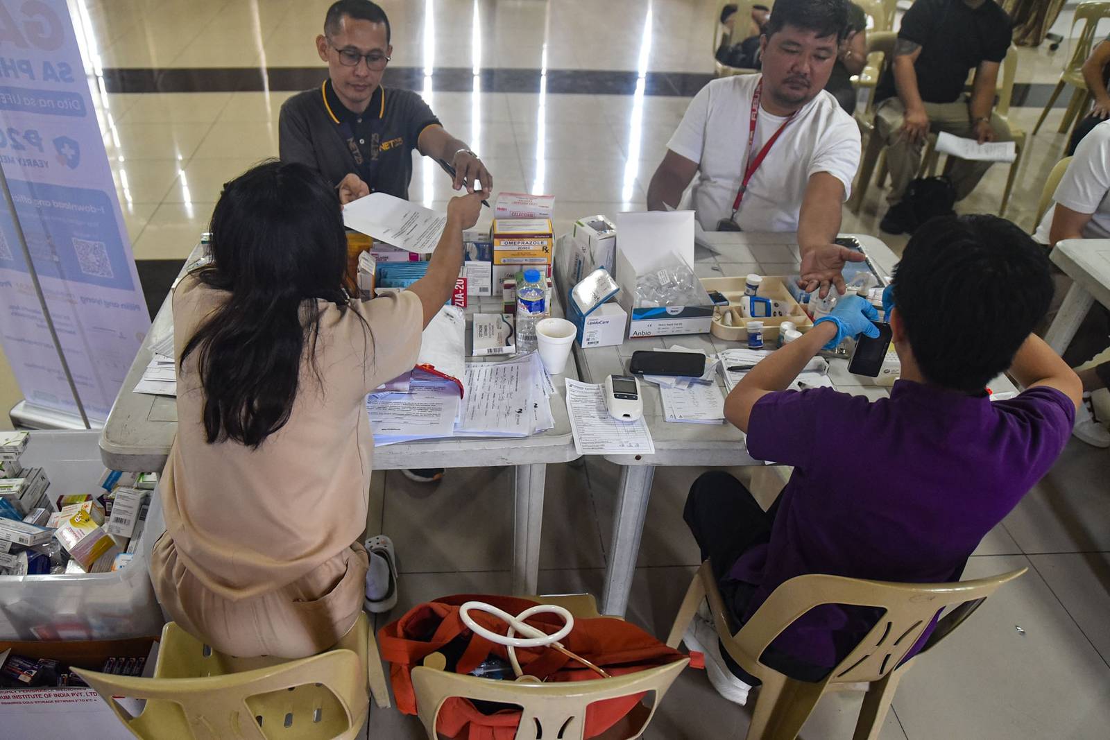 Members of the media and their relatives receive medical services during a medical mission organized by the National Press Club of the Philippines (NPC), in partnership with the Department of Health (DOH) and Lifesaver, in Intramuros, Manila, on October 26.

The medical mission coincides with the NPC’s 74th founding anniversary. | Zedrich Xylak Madrid