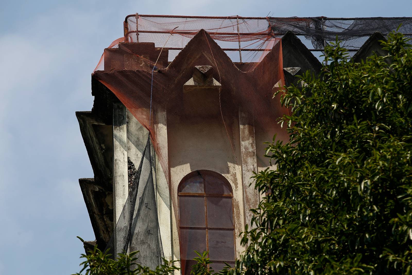 Protective nets cover the pre-war Art Deco IDES O’Racca Building in Divisoria, Manila, to shield vendors, shoppers and pedestrians from falling debris in this photo taken on 26 October 2026. Declared a cultural property by the National Museum of the Philippines, the building reportedly faces demolition despite calls for its preservation by heritage groups.