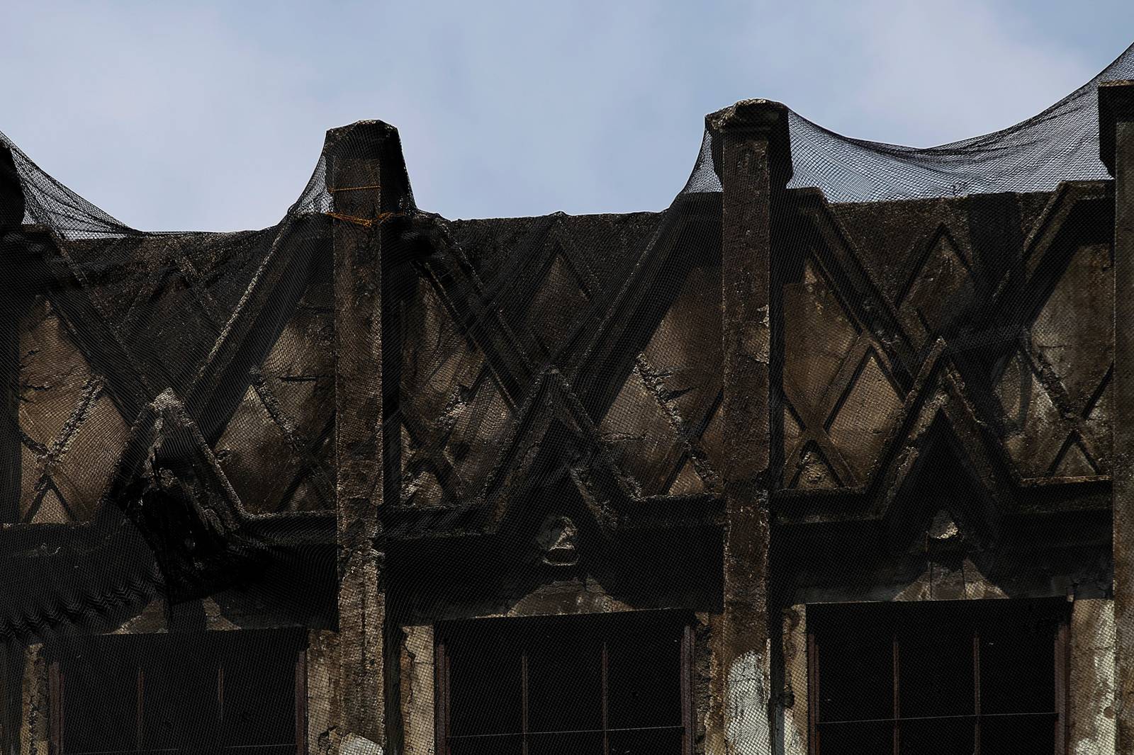 Protective nets cover the pre-war Art Deco IDES O’Racca Building in Divisoria, Manila, to shield vendors, shoppers and pedestrians from falling debris in this photo taken on 26 October 2026. Declared a cultural property by the National Museum of the Philippines, the building reportedly faces demolition despite calls for its preservation by heritage groups.