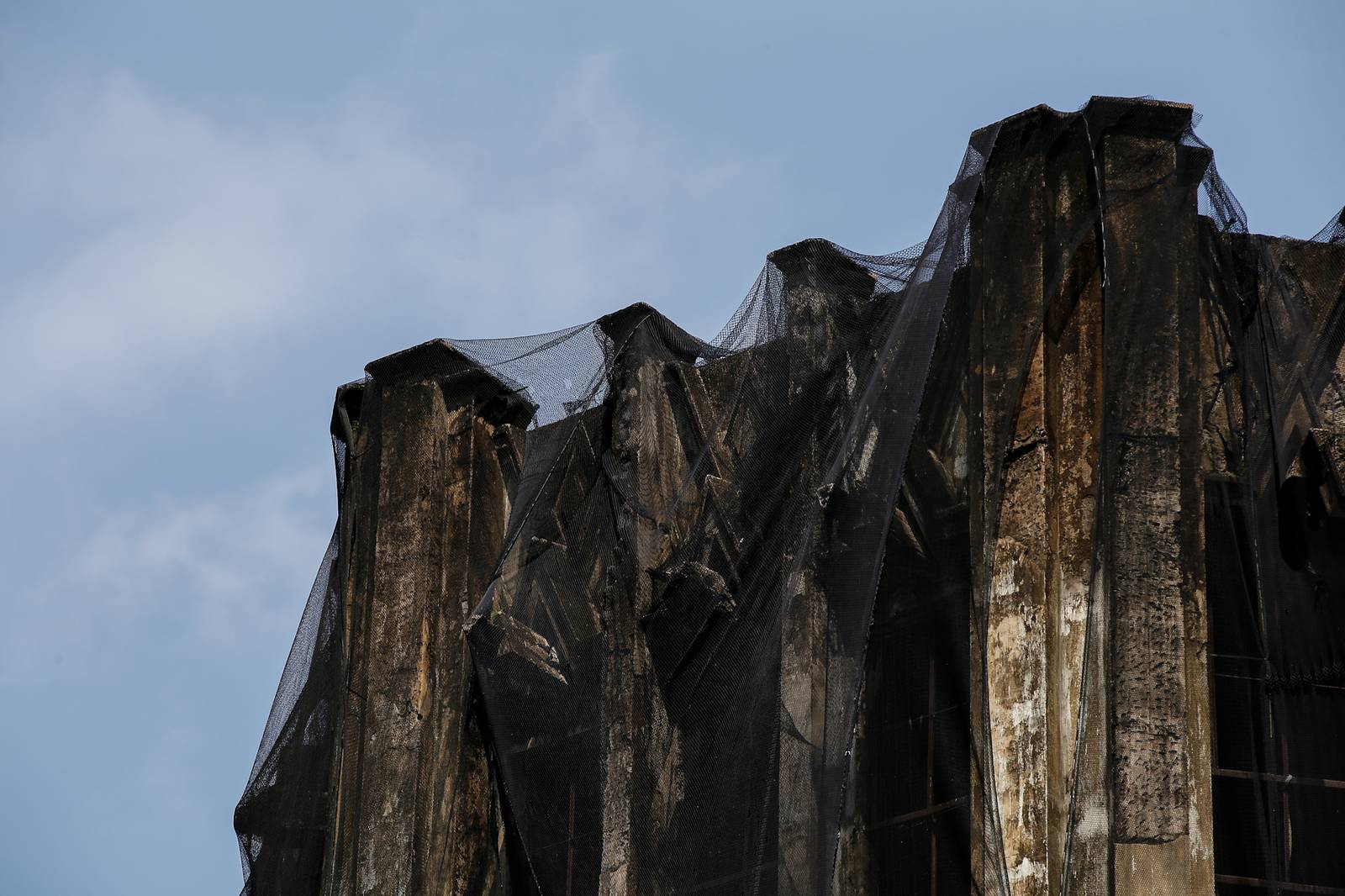 Protective nets cover the pre-war Art Deco IDES O’Racca Building in Divisoria, Manila, to shield vendors, shoppers and pedestrians from falling debris in this photo taken on 26 October 2026. Declared a cultural property by the National Museum of the Philippines, the building reportedly faces demolition despite calls for its preservation by heritage groups.