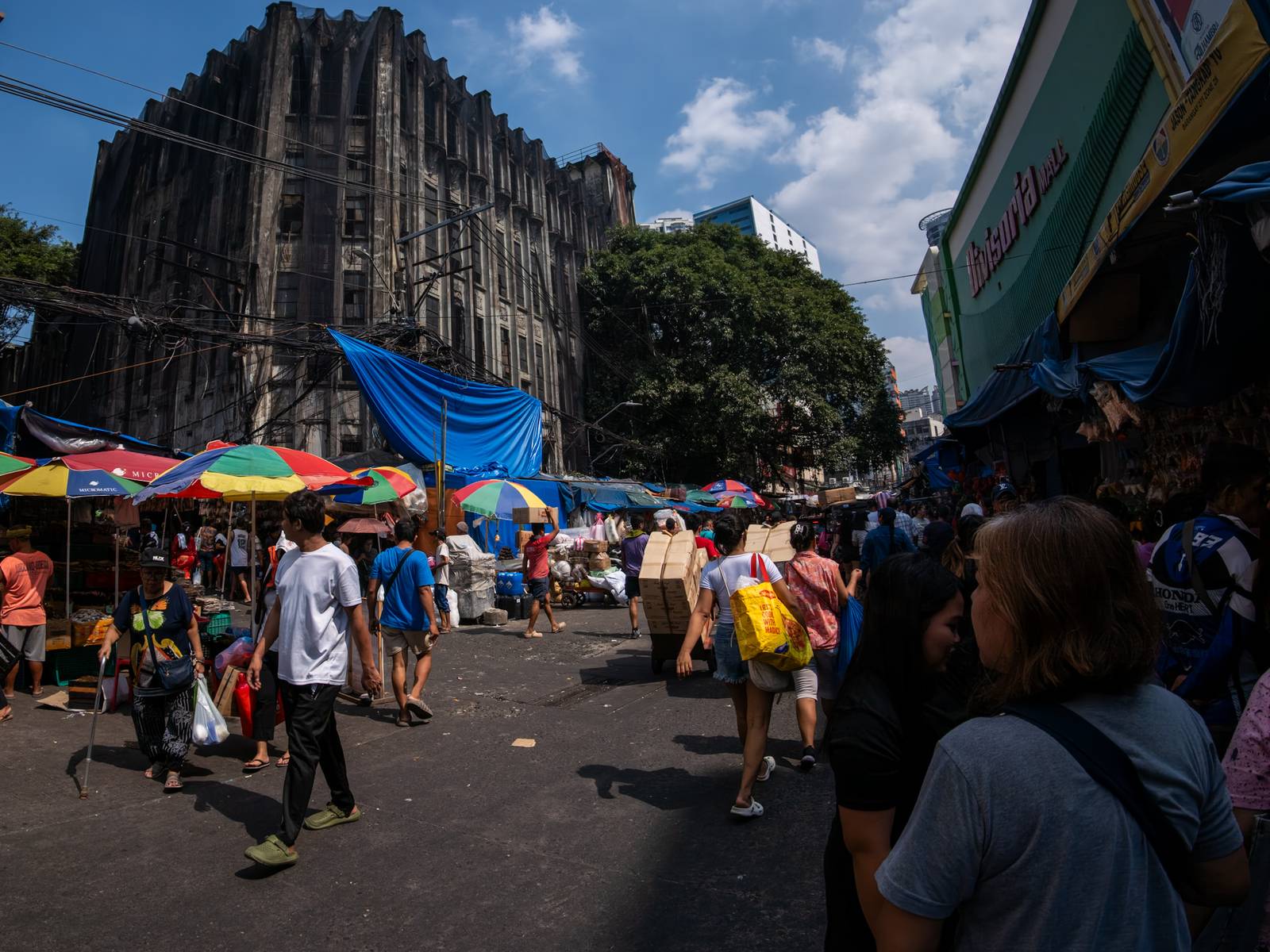 Protective nets cover the pre-war Art Deco IDES O’Racca Building in Divisoria, Manila, to shield vendors, shoppers and pedestrians from falling debris in this photo taken on 26 October 2026. Declared a cultural property by the National Museum of the Philippines, the building reportedly faces demolition despite calls for its preservation by heritage groups.