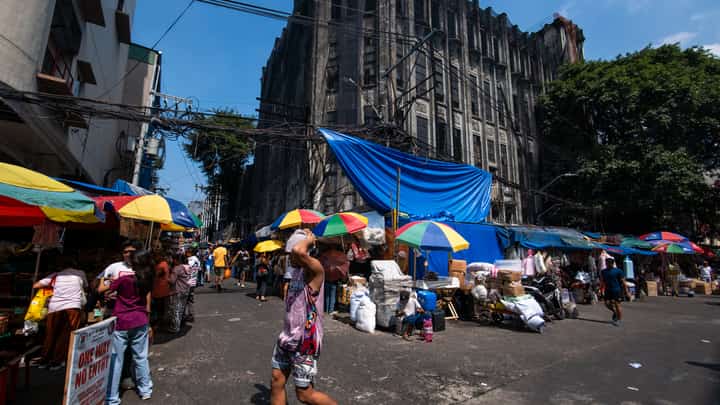 Protective nets cover the pre-war Art Deco IDES O’Racca Building in Divisoria, Manila, to shield vendors, shoppers and pedestrians from falling debris in this photo taken on 26 October 2026. Declared a cultural property by the National Museum of the Philippines, the building reportedly faces demolition despite calls for its preservation by heritage groups.