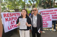 Mrs. Monalie Dizon, complainant, holding the document of her complaint, accompanied by VACC Chairman Manny Obedoza on Tuesday infront of Sta. Rosa Hall of Justice. Courtesy of VACC