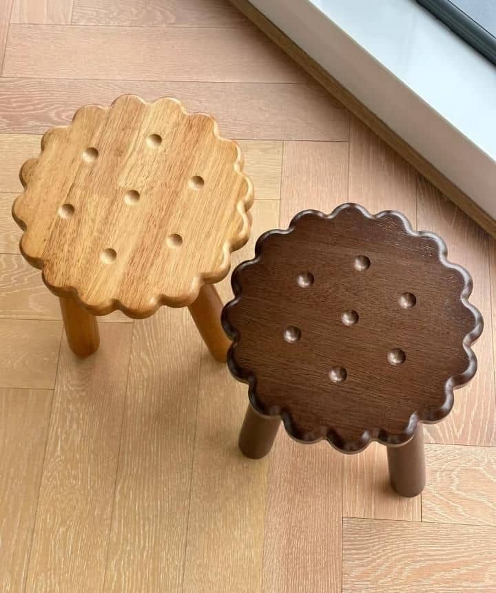 BISCUIT-SHAPED solid wood stools.