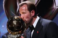 England and Bayern Munich forward Harry Kane kisses the trophy on stage after receiving the Ballon d'Or award for the best male footballer during the 2026 Ballon d'Or France Football award ceremony at the Palladium Theatre in London on October 26, 2026.
