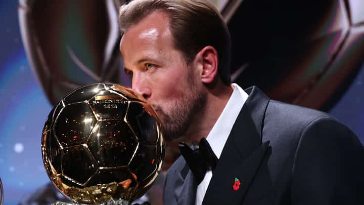 England and Bayern Munich forward Harry Kane kisses the trophy on stage after receiving the Ballon d'Or award for the best male footballer during the 2026 Ballon d'Or France Football award ceremony at the Palladium Theatre in London on October 26, 2026.