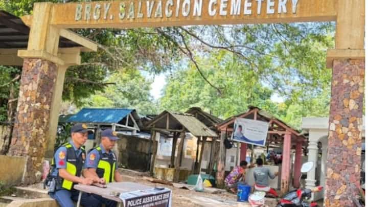 UNDAS SECURITY. Two police officers man a Police Assistance Desk at Barangay Salvacion Cemetery in Busuanga, Palawan, as authorities strengthen security at 43 cemeteries across the province ahead of All Saints' Day and All Souls' Day.
