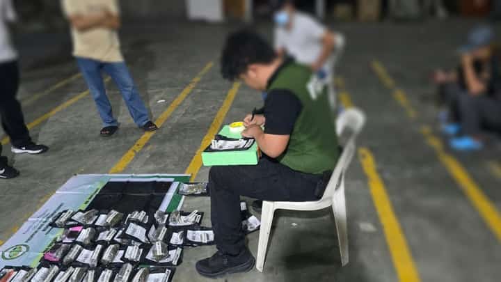 COURIER HUB SEIZURE. A Philippine Drug Enforcement Agency operative documents suspected marijuana products recovered during a K9-assisted inspection at a courier hub in Barangay San Vicente, San Pedro City, Laguna, on 30 October 2026. Authorities seized approximately 250 grams of suspected marijuana products valued at ₱30,000.