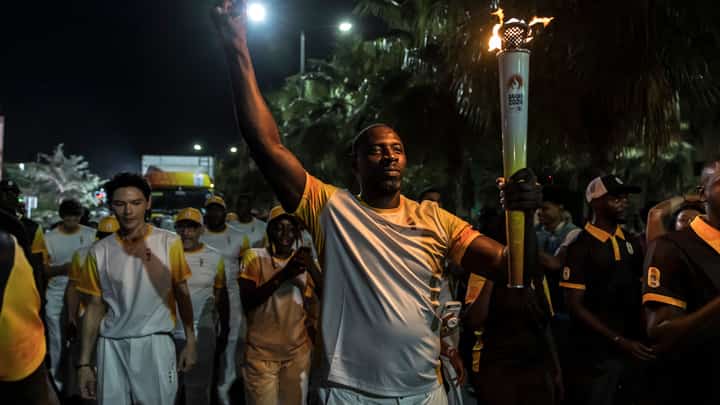 FRENCH actor Omar Sy carries the Olympic flame signaling the start of the 4th Youth Olympic Games, the first ever Olympic Games that will be held on African soil.